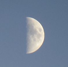 the moon is in the clear blue sky