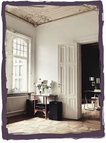 a room with white walls and wooden floors