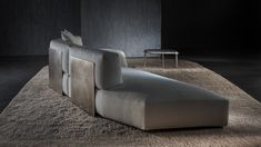 a couch sitting on top of a carpet covered floor