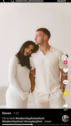 a man and woman standing next to each other in front of a white wall with text