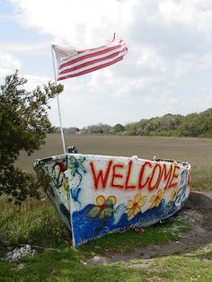 a boat with the word welcome painted on it and an american flag sticking out of it