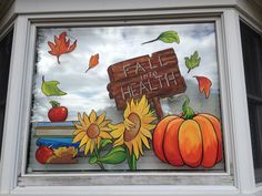 a window with fall and health painted on it