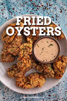 fried oysters on a white plate with dipping sauce in the middle and text overlay that reads fried oysters