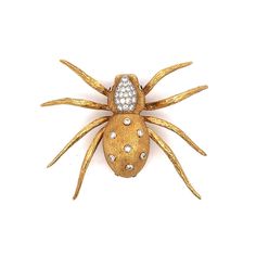 Estate Diamond Spider Brooch in 18k Solid Yellow Gold This Modern spider brooch adds a unique sparkle to any collection with its captivating design. Crafted in 18 karat yellow gold, the brooch features round brilliant cut diamond at its center, weighing .94 carats with a clarity of VS2 and an H color grade. The spider's body is adorned with additional bezel set and pave set diamonds totaling .06 carats, providing an extra layer of shimmer. The eyes of the spider are highlighted by two vibrant em Diamond Yellow Gold Brooches Fine Jewelry, Yellow Gold Diamond Brooch Fine Jewelry, Yellow Gold Diamond Brooches Fine Jewelry, Yellow Gold Diamond Brooch In Fine Jewelry Style, Formal Yellow Gold Brooches With Single Cut Diamonds, Fine Jewelry Diamond Brooch In Gold, Yellow Gold Diamond Brooches For Formal Occasions, Diamond Yellow Gold Brooch For Anniversary, Gold Diamond Brooches As Gift