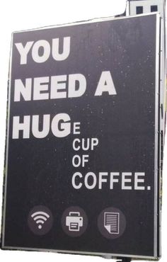 a sign that says you need a hug a cup of coffee