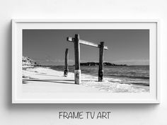 a black and white photo with the words frame tv art in front of an empty beach