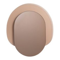 the back side of a light brown and beige door handle on a white wall with an oval