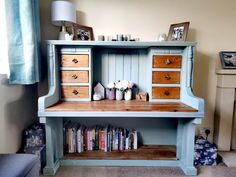 a blue desk with drawers and books on it