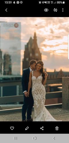 a man and woman standing next to each other in front of a cityscape