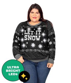 a woman wearing an ugly sweater with the words let it snow on it and stars