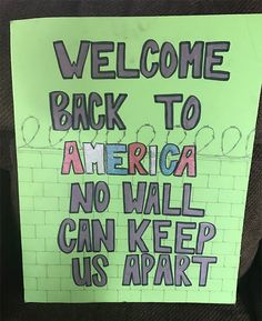 a sign posted on the back of a car that says, welcome back to america no wall can keep us apart