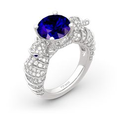 Dramatic, different and distinctive, this handcrafted sea horse ring makes any day special. It features a blue round cut stone at the center, while two sea horses wrap the center stone in a sparkling embrace and continue into the ring's shank. The sea horses' eyes are decorated with shimmering stones for a touch of sparkle. This stunning look is sure to bring you instant compliments.Carat Weight: 6.55 ctStone Size: 10 mmStone Type: Jeulia® StoneNumber of Stones: 1 Stone Color: Sapphire BlueStone Shape: RoundCarat Weight: 3.017 ctStone Size: 3*3,1.1,0.9,1.3,1.1 mmStone Type: Jeulia® StoneNumber of Stones: 240 Stone Color: Diamond White, Sapphire BlueStone Shape: Heart, RoundWeight: 8.62 gWidth: 9.5 mmHeight: 9.1 mmThickness: 3.2 mmMaterial: 925 SilverPlating Color: Silver Gemstone Snake Ring Fine Jewelry, Elegant Snake Ring With Gemstone, Anniversary Snake Ring With Gemstone, Anniversary Gemstone Snake Ring, Ocean-inspired Round Ring For Anniversary, Blue Ocean-inspired Jewelry For Anniversary, Ocean-inspired Blue Jewelry For Anniversary, Sea Ring, Horse Ring