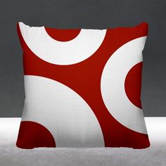 a red and white pillow with circles on it