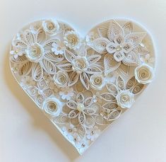 a paper heart with flowers on it