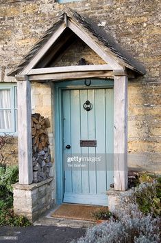 an old stone building with a blue door