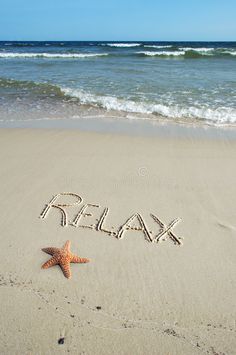 the word relax written in sand next to a starfish