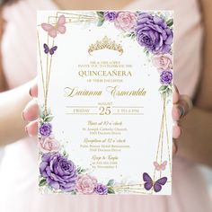 a woman in a pink dress holding up a card with purple flowers and butterflies on it