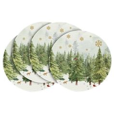 four plates with trees and snowflakes on them