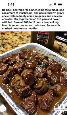 a pan filled with meat covered in gravy on top of a counter