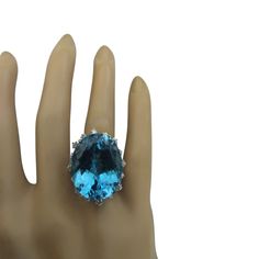 Stamped: 14K Total Ring Weight: 7.2 Grams Topaz Weight 33.57 Carat (22.75x18.00 Millimeters)Diamond Weight: 0.55 carat (F-G Color, VS2-SI1 Clarity )Face Measures: 27.90x21.50 Millimeter SKU: [600818] Oval Blue Topaz Diamond Ring For Formal Occasions, Luxury Oval Topaz Ring For Formal Occasions, Pear-shaped Topaz Ring For Formal Occasions, Formal Oval Topaz Gemstone Ring, Formal Blue Pear-shaped Topaz Ring, Formal Oval Hallmarked Topaz Ring, Formal Oval Topaz Ring Hallmarked, Formal Oval Topaz Ring, Formal Pear-shaped Topaz Ring Fine Jewelry