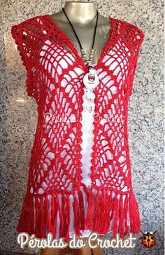 a mannequin wearing a red crochet top with fringes on it