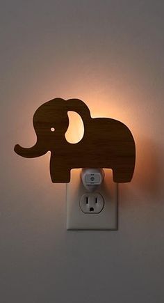 an elephant night light is mounted on the wall