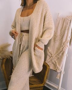 Relaxed Fit 73% Acrylic and 27% Polyester Dry Clean Long Sleeves Side Pockets Knit Fabrication Open Front No Closures Not Lined Lounge all day in this cozy oatmeal set! Our Rylin Pocketed Knit Cardigan is designed with side pockets and an open front. Pair this cardi with the matching top and pants. Just add fuzzy slippers! Styled with the Minimal Herringbone Necklace. Better Days Beaded Lariat. Winterful Life Knit Crop Top. Winterful Life Knit Drawstring Pants. Calvin Faux Fur Slide Sandal.---SI Cardigan And Pants Set, Neutral Matching Set, Lounge Set Outfit, Neutral Loungewear, Matching Lounge Set, Faux Fur Slides, Herringbone Necklace, Fuzzy Slippers, Scooped Neckline