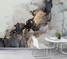 a white table and chairs in front of a wall with an abstract painting on it