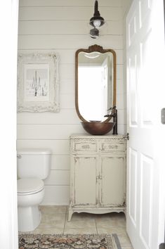 a bathroom with a sink, mirror and rug on the floor in front of it