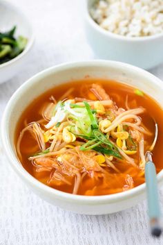 a bowl of soup with noodles and vegetables in it