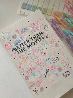 a notebook with the words better than the movies written on it next to markers and pens