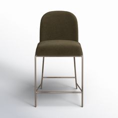 an upholstered chair with a metal frame on the back and armrests