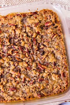 a casserole dish with pecans and other toppings in it on a table