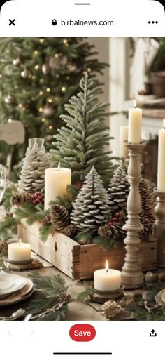 a christmas table setting with pine cones and candles