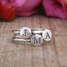 "Stack our initial bands to say whatever you want - Spell a name, wear an initial for each member of the family, or create a couple's ring with two initial bands stacked with a heart band in the middle. The possibilities are endless! **The base price of this listing is for one sterling silver initial ring with one initial/symbol per band. If you choose more rings, the price will increase. Rings available in all letters, the heart symbol, the cross symbol and the & sign** Want to add birthsto Rings With Initials, Personalized Initial Ring, Silver Initial Ring, Initial Rings, Birthstone Stacking Rings, Mothers Ring, Diamond Wedding Jewelry, Family Rings, Sterling Silver Stacking Rings