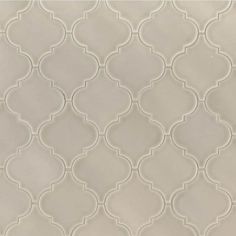 a white tile with an intricate design on it