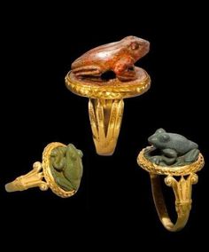 three rings with frog figurines on them