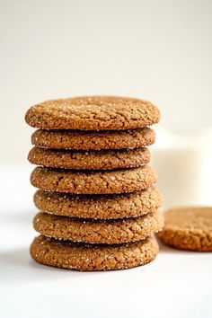 a stack of cookies next to a glass of milk