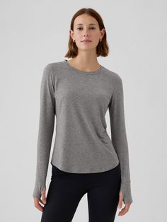 Soft, lightweight T-shirt.  Crewneck.  Long sleeves.  Moisture-wicking helps keep your skin dry.  This product was made in a factory that invests in gender equality and women’s empowerment.  Through RISE Reimagining Industry to Support Equality) and Gap Inc. ’s program P. A. C. E.  Personal Advancement & Career Enhancement), we support people who make our clothes to build the skills, knowledge, confidence, and resilience needed to advance in work and life.  Learn more here.  Fit: Classic.  A str Gender Equality, Support People, Long Sleeve Striped Top, Gap Fit, Roll Up Sleeves, Grey Top, Grey Shirt, Henley Shirts, Crop Shirt