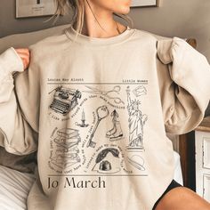 Get ready to be OBSESSED with your new Little Women Jo March shirt. It's the cutest and most trendy way to emit all those important book worm vibes! This is the perfect bookish shirt! Great as a gift! * Q U I C K * F A C T S * ✺ 100% preshrunk cotton ✺ Wash and dry normally (on cool for best results) * S I Z I N G * ✺ Sizing is unisex so runs like men's, though not overly large ✺ Most women find their typical size works best, since they are meant to fit a touch loose ✺ Size guide and fit: * S H Bookish Crew Neck Top With Character Print, Bookish Cotton Tops With Character Print, Bookish Long Sleeve Cotton Tops, Little Women Jo March, Meg March, Jo March, Louisa May Alcott, Women Sweatshirt, Little Women