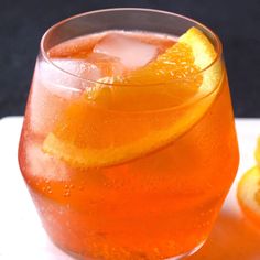 a drink with orange slices on the rim