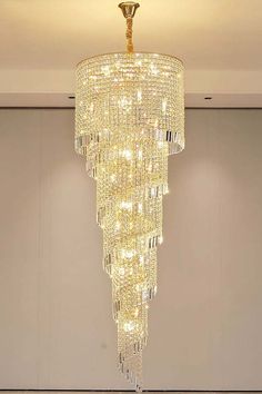 a chandelier hanging from the ceiling in a room with white walls and flooring