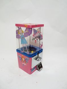 a pink and blue ice cream vending machine sitting on top of a white table