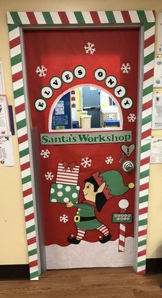 the door to santa's workshop is decorated with candy canes