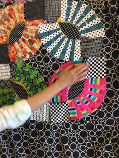 a person is working on an art project with colorful paper pieces in the shape of sunflowers