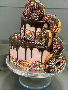 a triple layer cake with chocolate frosting and sprinkles