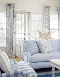 a living room with blue and white furniture