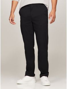 Tommy Hilfiger men's pant. These pants have the look of trousers but are made from stretch nylon to offer total flexibility and comfort, perfect for traveling or just your daily commute to the office.  Material: 95% Polyamide, 5% Elastane. Tommy Hilfiger Straight Leg Pants For Work, Tommy Hilfiger Straight Leg Business Casual Bottoms, Straight Leg Cargo Pants With 4-way Stretch For Work, Casual Straight Leg Pants For Golf, Casual Straight Leg Golf Pants, 4-way Stretch Straight Leg Cargo Pants For Work, 4-way Stretch Dress Pants For Business Casual, Tommy Hilfiger Straight Leg Work Pants, Tommy Hilfiger Tapered Leg Work Pants