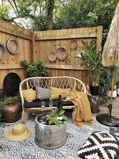 an outdoor patio with wicker furniture and potted plants