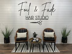 two chairs sitting next to each other in front of a sign that says foot & fade hair studio